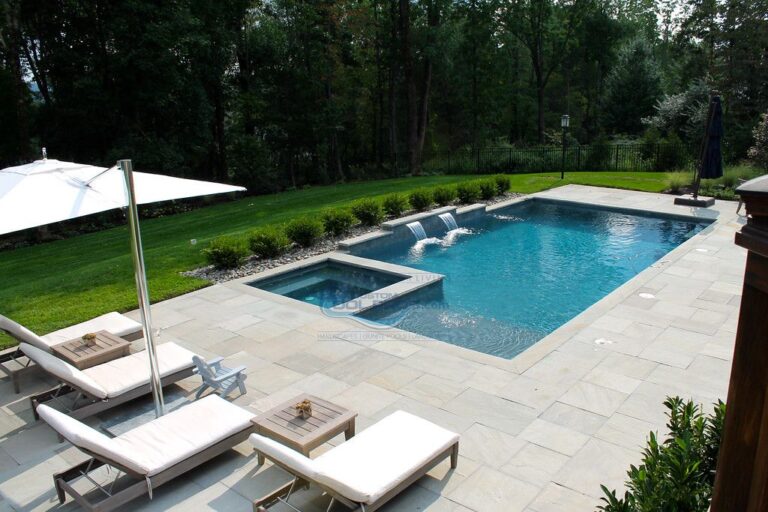 gunite pool installation with waterfalls, square spa and pool patio