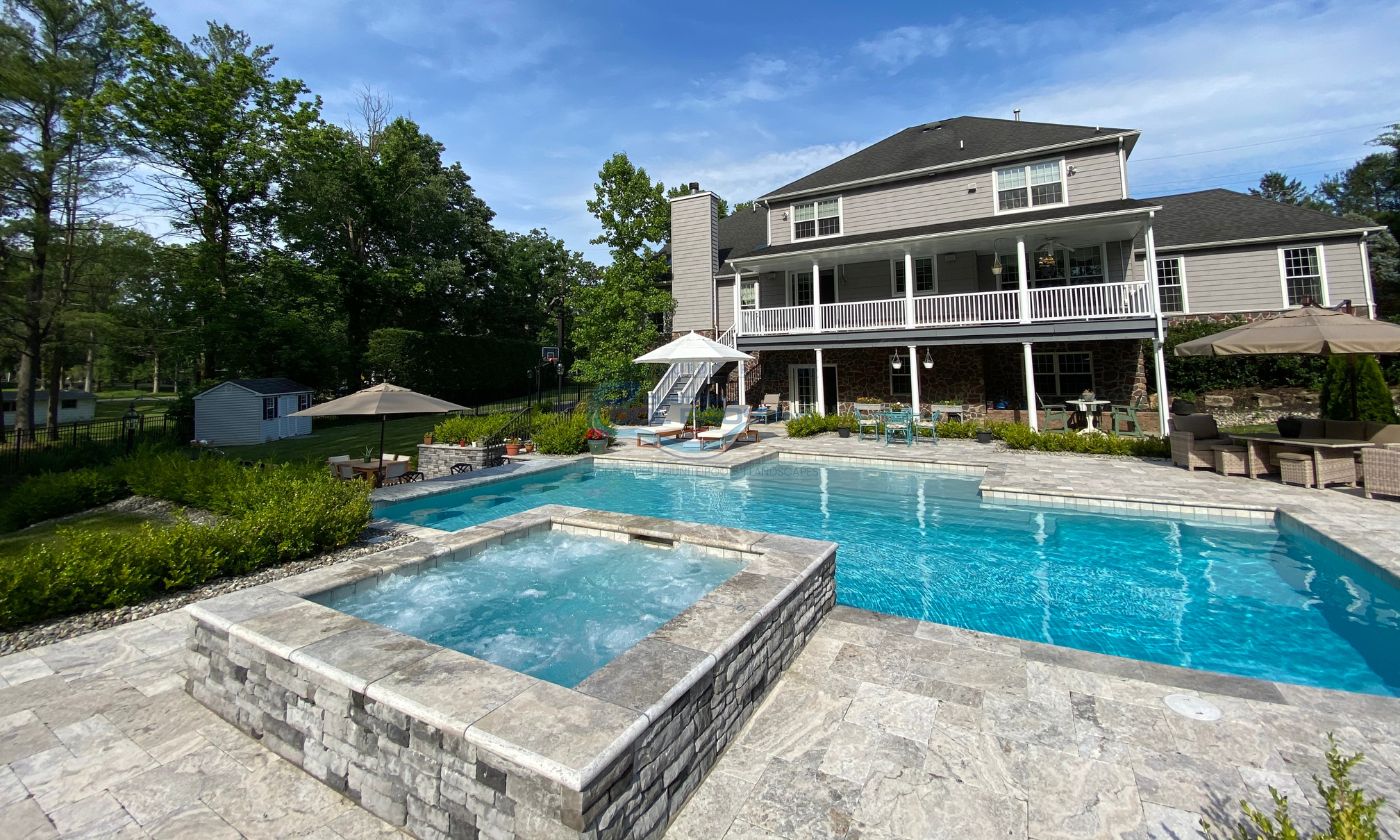 gunite pool installation with raised spa in Livingston, NJ