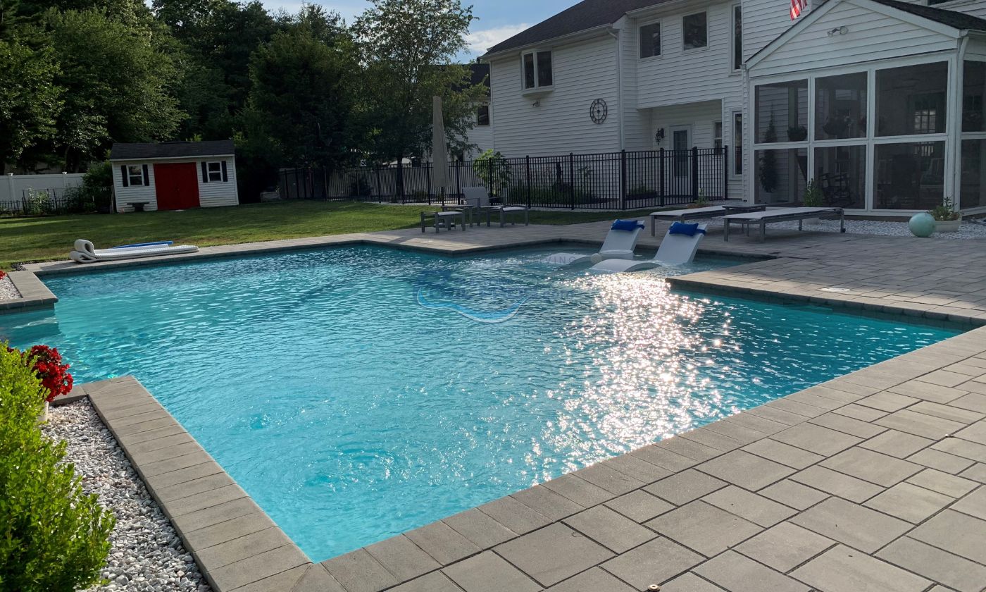 inground pool installation with water lounge chairs in NJ