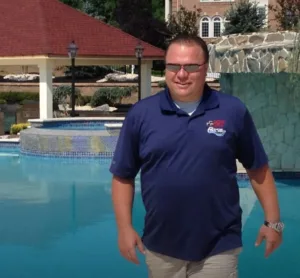 Tom Lobrow, founder and owner of Custom Pool Pros, beside a custom swimming pool project in New Jersey