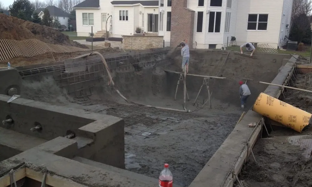 applying gunite concrete over rebar in an inground swimming pool construction build