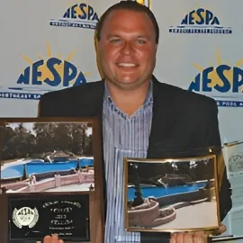 Custom pool builders serving all of New Jersey, standing beside NESPA pool awards